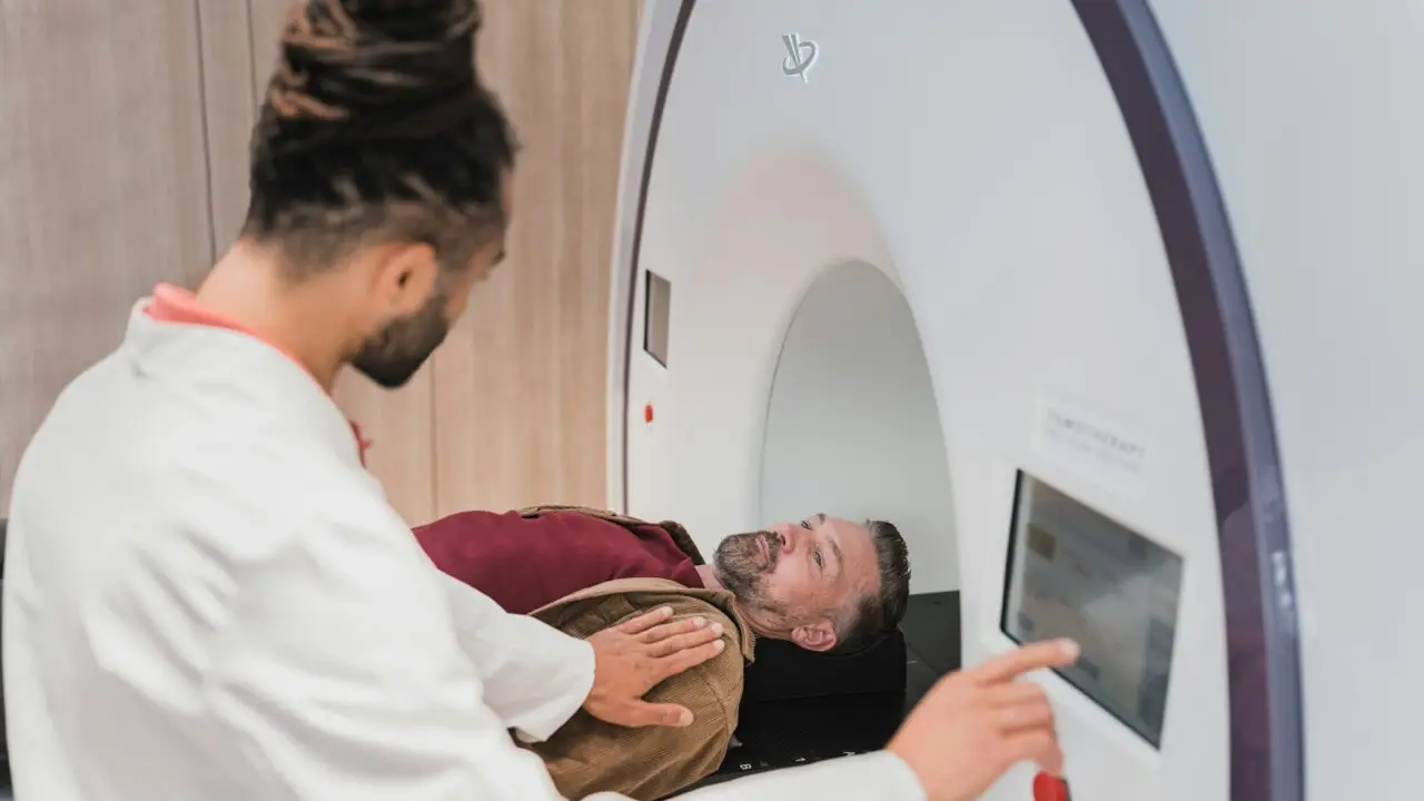 Doctor guiding a patient through a body scan procedure during Nura AI health screening.