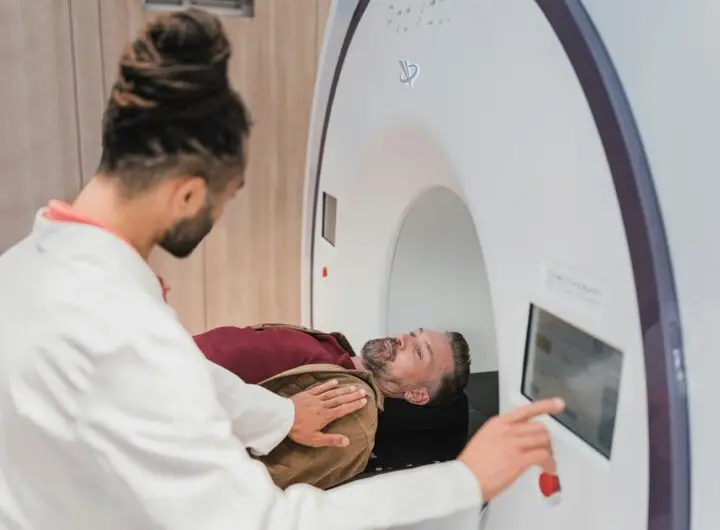 Doctor guiding a patient through a body scan procedure during Nura AI health screening.