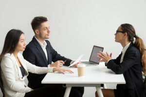 Young professional tackling Python interview questions in a formal interview setting.