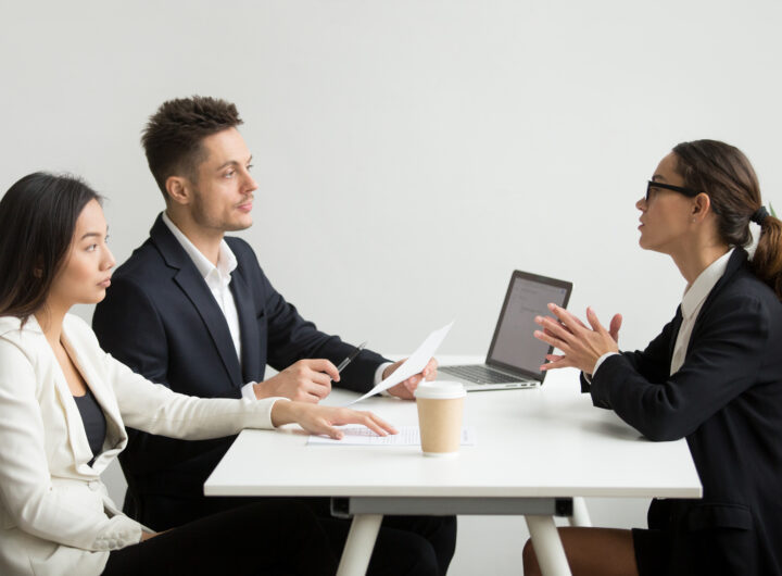 Young professional tackling Python interview questions in a formal interview setting.